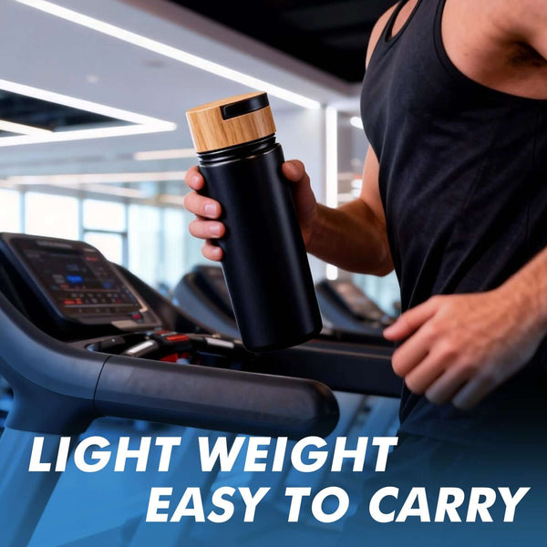 Black insulated sports water bottle held by a person on a treadmill, showcasing its lightweight and portable design.