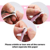 Hands demonstrating how to crinkle or tear a corner of glossy photo sticker paper for inkjet printers.